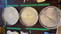 Top view of all three round trays showing size and engraved pattern