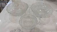 three opalescent cherry-pattern bowls displayed on countertop