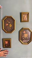 All four framed wood marquetry pictures with measuring tape for scale