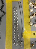 Both necklaces laid out within lot boundaries