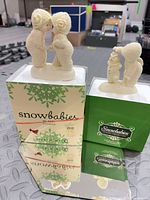 Both figurines displayed atop their original Snowbabies boxes