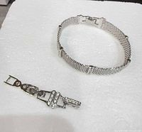 Bracelet band and separate clasp component on white background