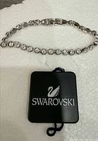 Full view of Swarovski crystal tennis bracelet with branded tag