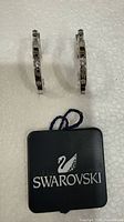 Earrings with Swarovski tag visible