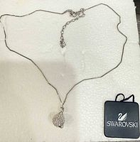 Full view of necklace with pendant and Swarovski case