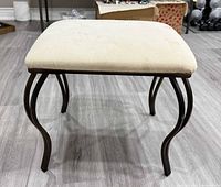 Full view of bench showing cushion and metal legs