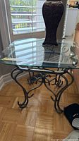 Front angle of glass-top end table showing entire piece