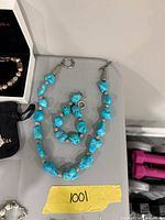 Necklace and bracelet laid flat showing full length and clasps