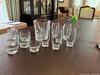 Entire set laid out showing all glasses, ice bucket and tongs