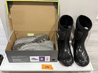 Bogs boots next to open box containing Eddie Bauer hiking shoes