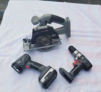 Group shot of circular saw, drill, work light with battery packs