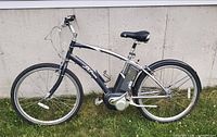 Left-side overview of electric bicycle showing full frame, motor, battery, wheels and accessories