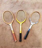 Front view of all three racquets side-by-side