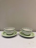 Two cups and two saucers assembled