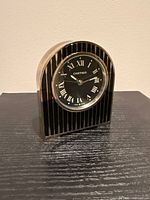 Front view of Cartier desk clock showing dial and striped case