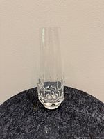 Full front view of clear crystal bud vase standing upright