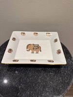 Top view showing elephant motif and gold rim