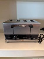 Front view showing Hobart logo, dual levers, control knobs, power cord