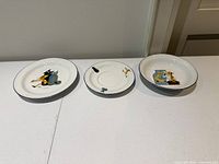 Three Richard Ginori Pinocchio porcelain pieces side by side