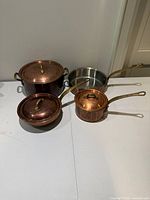 All three Williams-Sonoma France copper pots with lids displayed together