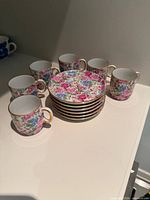 All six demitasse cups and saucers stacked