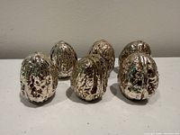 Front view of all six sterling silver walnuts