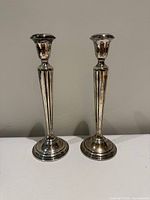 Front view of both Cartier candlesticks showing full height and design