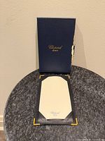 Jotter open with writing pad, presentation box standing rear