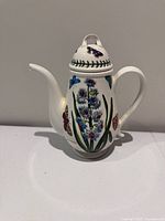 Full view of coffee pot front showing floral and butterfly design