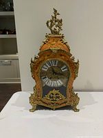 Full frontal view of mantel clock showing overall design and missing numerals
