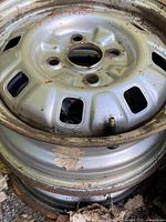 Top view of stacked steel rims showing ventilation slots and lug pattern
