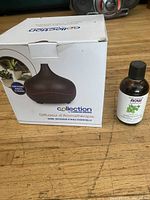 Boxed Collection 300mL diffuser beside Now peppermint essential oil bottle