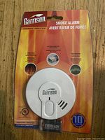 Front of sealed Garrison smoke alarm package with Eveready battery visible
