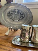 Front view showing pewter plate, shakers and tray
