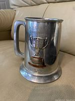 Front view of pewter mug showing Roughriders text and Grey Cup graphic