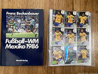 Book and sleeve of trading cards side by side