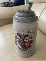 Front view showing crest and mottos on stein