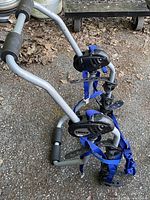 Angled view of assembled grey Thule bike rack showing frame, cradles and blue straps