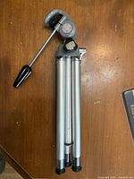 Tripod folded showing legs, head and handle