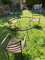 table frame and three chairs on lawn
