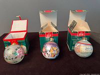 Three Hallmark ornaments with boxes displayed front