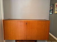 Front view of lower teak cabinet, closed