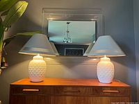 Both matching lamps on dresser, lit, showing overall design and shades