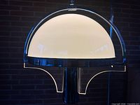 Front view showing white glass globe within chrome and lucite frame