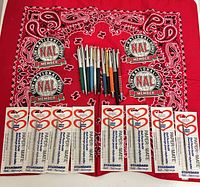 Overall lot laid out: pens, eight refill packs, four NAL stickers, red bandana