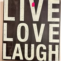 Front view of distressed 'Live Love Laugh' wall sign