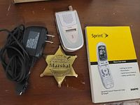 Phone, charger, badge, manual grouped