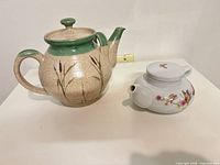 Both teapots side by side showing overall forms and scale