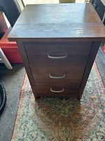Front view showing three drawers and silver bar handles