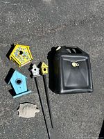 All six items laid out: oil drain pan, four birdhouses, stone turtle